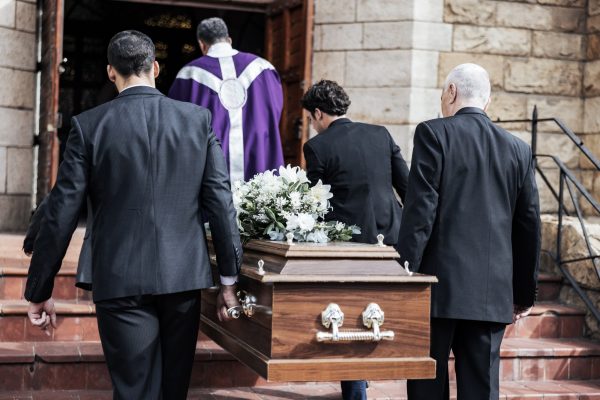 death-funeral-and-holding-coffin-in-church-for-grief-bereavement-and-with-family-together-on-step.jpg