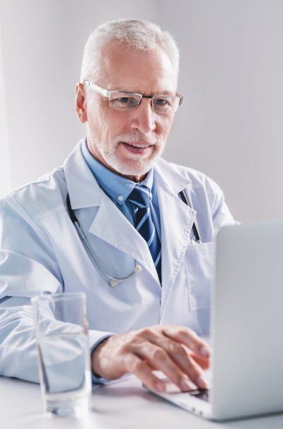 doctor-online-senior-medic-talking-to-client-on-laptop-computer-from-his-office-e1704840763674.jpg