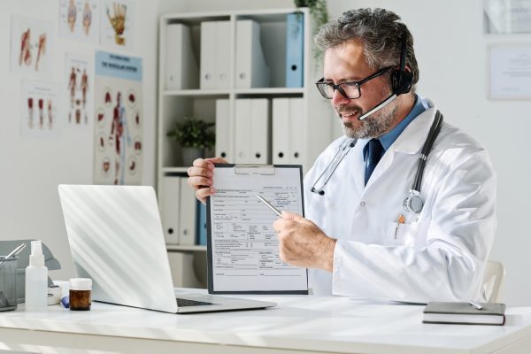 doctor-prescribing-treatment-online-at-office.jpg